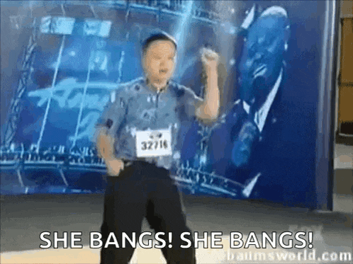 a young boy is dancing in front of a wall with the words she bangs she bangs written on it