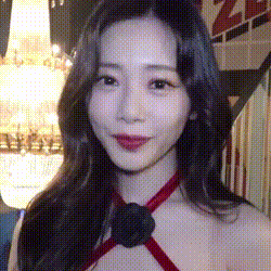 a close up of a woman wearing a red dress with a black bow around her neck .