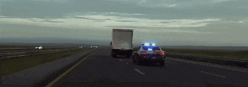 a truck is being pulled by a police car