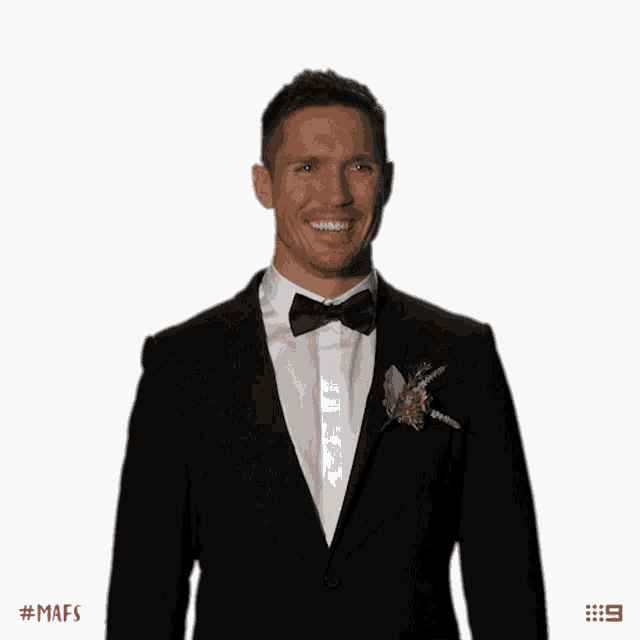 a man in a tuxedo with a flower in his lapel has the number 9 on the bottom right