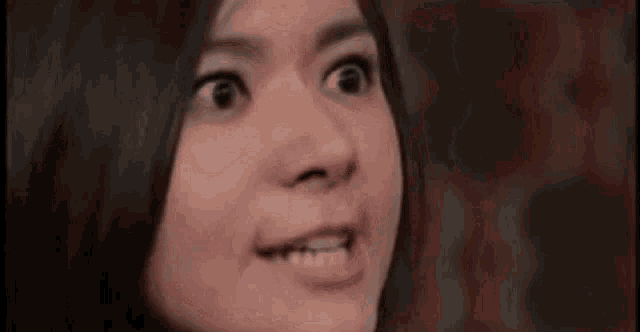 a close up of a woman 's face making a funny face .