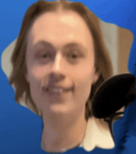 a blurry picture of a man 's face with a microphone in the background
