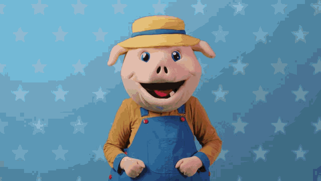 a pig mascot is wearing overalls and a hat and giving a thumbs up