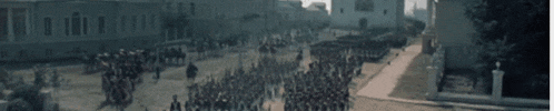 a crowd of people are gathered in front of a wall