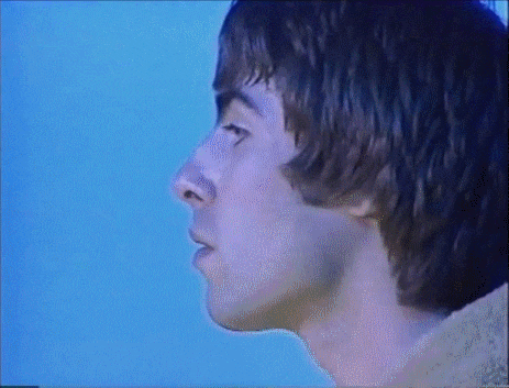 a close up of a man 's face against a blue sky