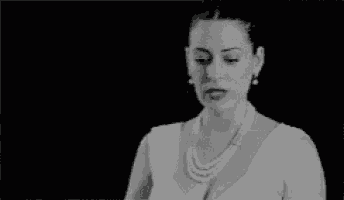 a black and white photo of a woman in a white dress