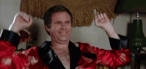 a man in a red robe is flexing his muscles .