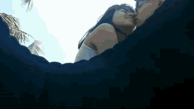 a man and a woman are kissing each other on the cheek
