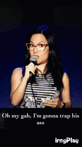 a woman speaking into a microphone with the words oh my gah i 'm gonna trap his ass below her
