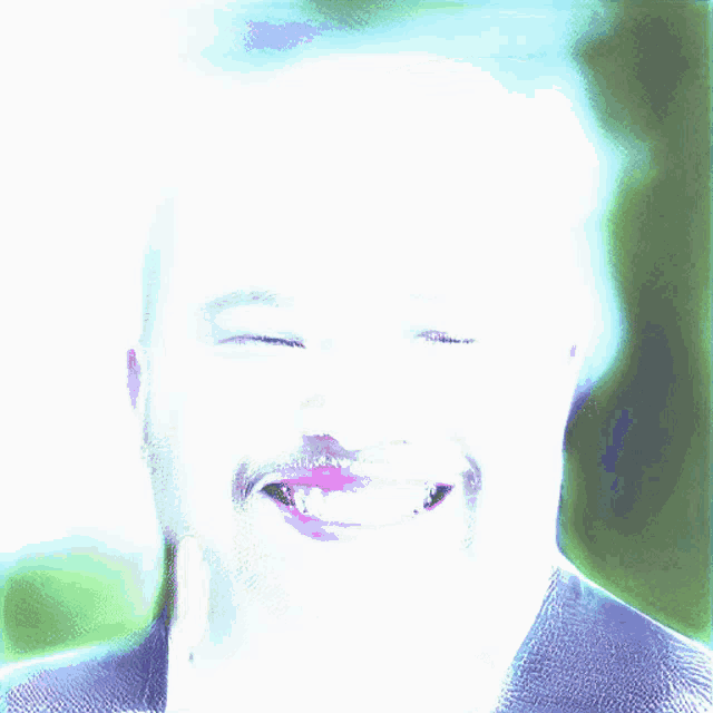 a close up of a man 's face with his eyes closed and his mouth open