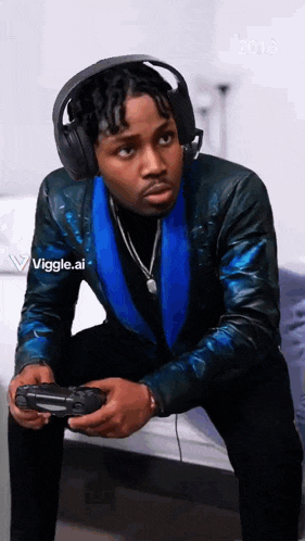 a man wearing headphones and a blue jacket is holding a video game controller ..