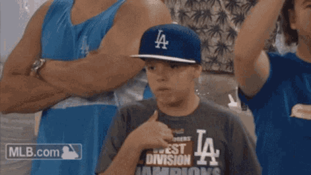 a boy wearing a la hat covering his face