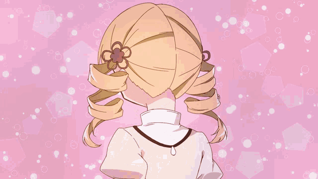a girl with blonde hair and a purple hat smiles on a pink background