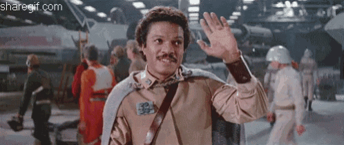 a man with a mustache is waving his hand in front of a group of people ..