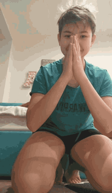 a young boy wearing a blue shirt that says virraw on it