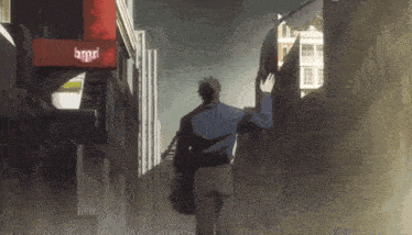 a man is walking down a street in front of a red sign that says bmgd