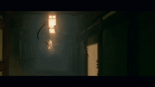 a person standing in a dark room with fire coming out of their mouth