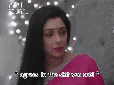 a woman in a pink saree is looking at the camera and agrees to the shit you said .