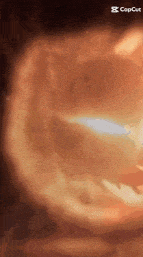 a close up of a person 's face with a glowing light coming out of it