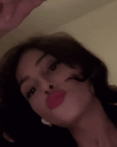 a close up of a woman 's face with red lipstick on