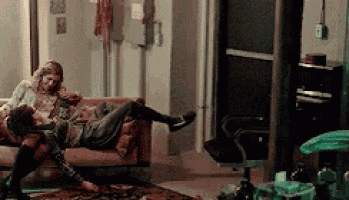 a man and a woman are sitting on a couch .