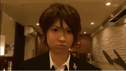 a woman in a suit has a treble clef embroidered on her shirt