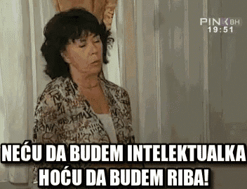 a woman is standing in front of a window with a sign that says necu da budem intelektualka hocu da budem riba .