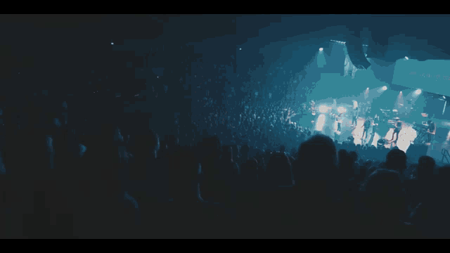 a woman sings into a microphone while another woman stands behind her