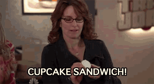 a woman is holding a cupcake sandwich in her hand and saying cupcake sandwich .