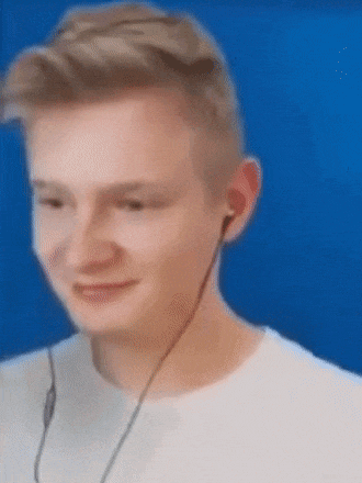 a young man wearing headphones and a white shirt is smiling .