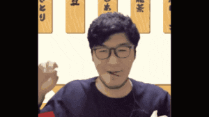 a man wearing glasses and a choker is eating food