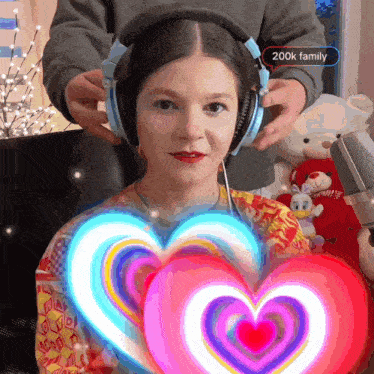 a girl wearing headphones with a 200k family sticker on her head