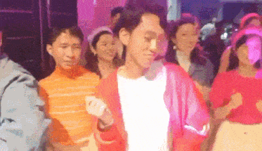 a group of people are dancing together in a club .