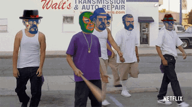 a group of men are walking down the street in front of a walt 's transmission and auto repair store