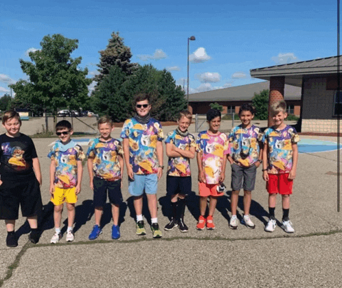 a group of young boys wearing colorful shirts with the numbers 6 and 6 on them