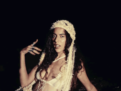 a woman in a very revealing outfit with a white headband