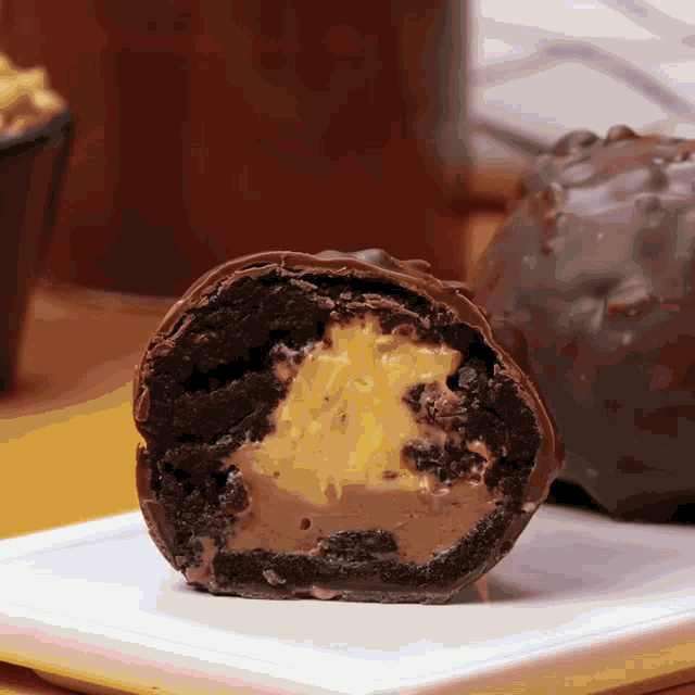 a piece of chocolate cake with a peanut butter filling on a white plate