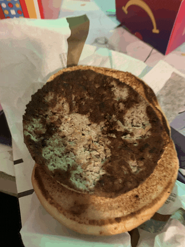 a dirty mcdonald 's hamburger bun with a smiley face on it