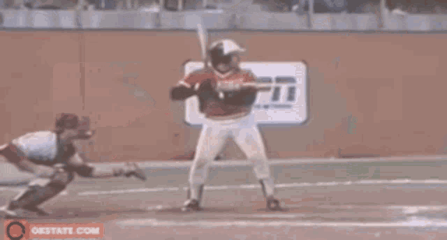 a baseball player wearing a red jersey with the word phillies on it .