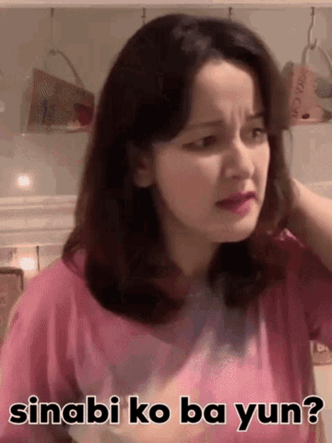 a woman in a pink shirt is making a funny face with the words sinabi ko ba yun written on the bottom