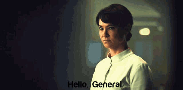 a woman in a white uniform says hello general in a dark room
