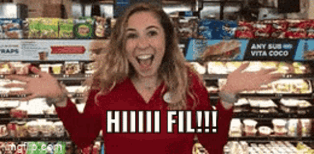 a woman in a red shirt is standing in a grocery store with her arms outstretched and says hiiiiii fill