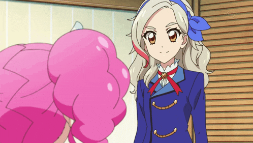 a girl in a blue jacket is standing next to a pink girl