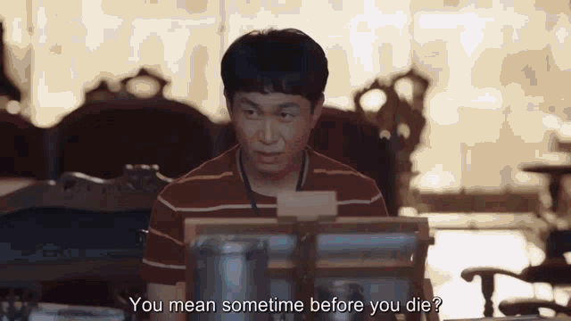 a man is sitting in front of a computer and talking .