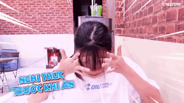 a girl wearing a white shirt that says one world one love