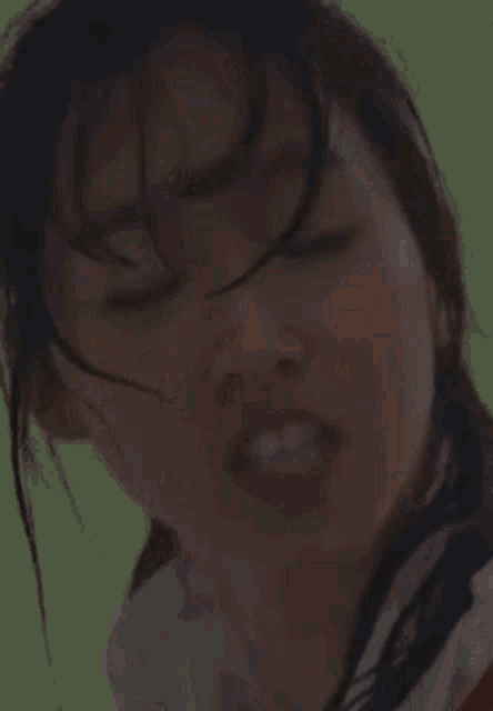 a woman in a school uniform and tie is making a face .