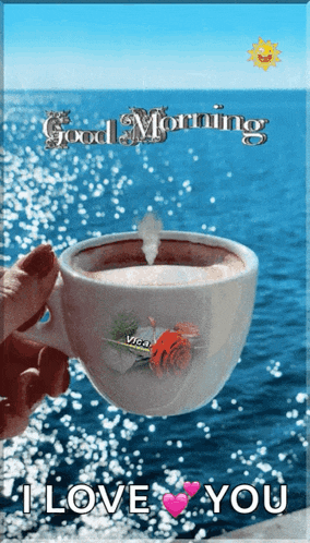 a woman is holding a cup of coffee in front of the ocean with the words good morning i love you