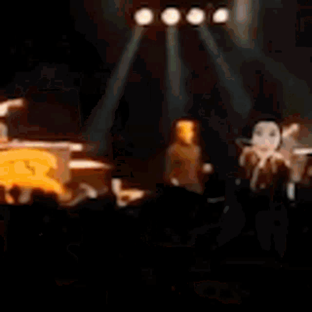 a man is singing into a microphone on a stage .