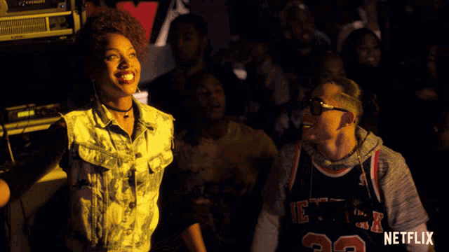 a man wearing a new york jersey is dancing with another man