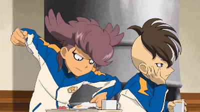 two anime characters are sitting at a table and one is holding a cup